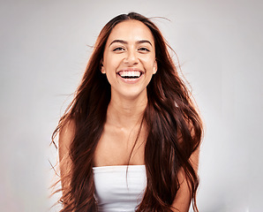 Image showing Cosmetics, portrait and woman with hair care, shine and girl with smile on grey studio background. Female, lady and happiness for salon treatment, scalp grooming and routine for volume and texture