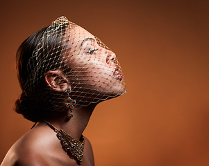 Image showing Net, veil and elegant woman in studio with stylish, fancy and fashion jewelry or accessories. Elegance, classy and female model with a vintage, glamour and retro accessory posing by brown background.