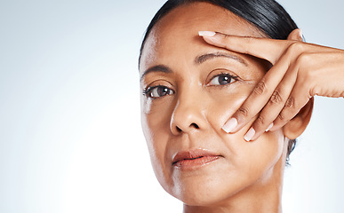 Image showing Face portrait, beauty and senior woman in studio isolated on gray background mockup. Makeup cosmetics, skincare or closeup of mature female model touching skin after spa facial treatment for wellness