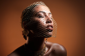Image showing Veil, elegance and woman in a studio with stylish, fancy and fashion jewelry or accessories. Elegant, classy and female model with vintage, glamour and retro net accessory posing by brown background.