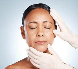 Image showing Botox, plastic surgery and hands check woman face for laser, cosmetics implant or beauty salon. Skincare consultation, facial or gloves of aesthetic change, liposuction or filler on studio background