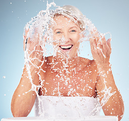 Image showing Shower, face and old woman with smile and water splash, clean skin and antiaging beauty, elderly model isolated on studio background. Senior skincare, cosmetics and facial portrait, happy and hygiene