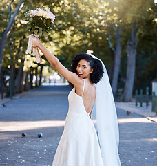 Image showing Bride, wedding and black woman with flowers at park outdoors. Portrait, marriage or beauty of happy female holding up floral bouquet of roses to celebrate at party, ceremony event or love celebration