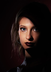 Image showing Portrait, beauty and makeup with a model woman in studio on a dark background for fashion or cosmetics. Face, light and glamour with an attractive young female posing on black space for style