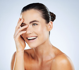 Image showing Beauty, skincare and hand on face of a woman in studio with a smile for natural cosmetic product. Aesthetic model person happy about makeup, facial and dermatology for skin glow and spa wellness