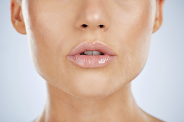 Image showing Makeup, lips and beauty of a woman in studio with lipstick for shine and natural glow cosmetics. Face, mouth and skin zoom of aesthetic model person for self care, skincare and facial wellness