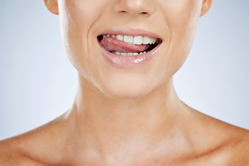 Image showing Woman, closeup and smile with tongue in studio for beauty, skincare and face by grey by background. Model, healthy mouth and teeth whitening with dental wellness, health and self care for aesthetic