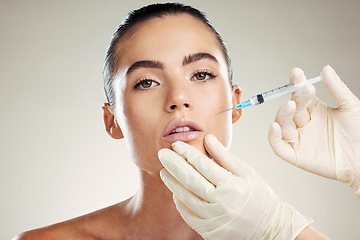 Image showing Skincare, collagen and portrait of woman with injection in lips from healthcare professional, anti aging treatment in studio. Beauty, model and aesthetic facial lip filler syringe on background