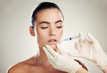 Image showing Skincare, collagen and aesthetic beauty, woman with injection in lips and treatment from healthcare professional. Mouth, needle and model with facial lip filler syringe on white background in studio