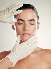 Image showing Patient, beauty and plastic surgery with hands on woman face for dermatology collagen cosmetics. Headshot of skincare model person with cosmetologist gloves for cosmetic filler for facial skin lines