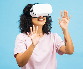 Image showing Black woman with virtual reality glasses, happy with hands in metaverse, VR and futuristic tech isolated on blue background. Gaming, web and augmented reality, ux in studio and future technology