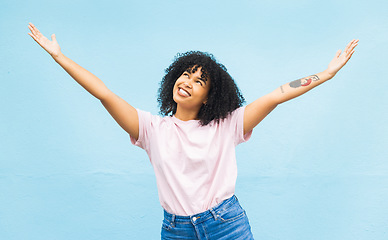 Image showing African woman, smile and open arms in studio for mockup, happiness celebration and excited in blue background. Black woman, happy and surprised hands gesture or celebrate surprise growth development