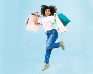 Image showing Happy, shopping and jump with portrait of black woman for spree, sale and summer discount. Retail therapy, spending and consumer deal with girl customer and bag for designer, products and purchase