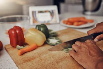 Image showing Kitchen, cutting board and vegetables being cut for cooking a healthy, organic and delicious meal. Food, nutrition and chef chop or preparing fresh produce peppers for a diet dinner, lunch or supper.