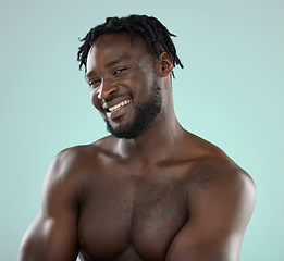 Image showing Happy man, skincare and face portrait with a smile for beauty, hygiene and grooming in studio. Healthy black person on blue background for facial glow, clean skin and self care with dermatology