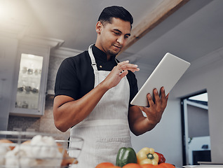 Image showing Man, cooking vegetables and tablet in kitchen while online with house wifi connection for learning or blog. Chef person with mobile app for online recipe for home food for vegan or healthy eating