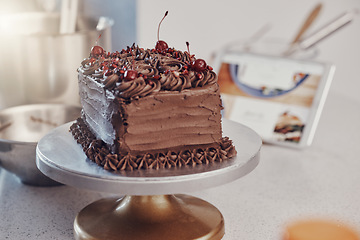 Image showing Chocolate cake, table and home with bakery dessert for fine dining, cooking or celebration with cream. Luxury birthday food, restaurant and sugar brownie with coco icing for eating, gourmet or baking