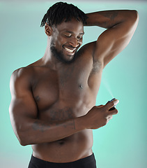 Image showing Black man, deodorant body spray and studio with smile for hygiene, clean and fresh fragrance by blue background. Happy gen z model, African and product for healthy underarm skin in hand for wellness