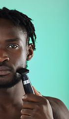 Image showing Shaving face with razor, black man in studio and skincare for smooth facial hair on green background. Confident young model grooming, hygiene and cleaning beard with cosmetic morning routine