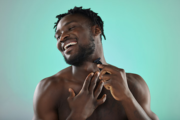 Image showing Black man shaving face, skincare on studio background and razor on smooth facial hair growth. Happy young person grooming, hygiene product and model cleaning beard with cosmetic morning routine