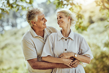 Image showing Love, hug or old couple in a park or nature bonding or holding hands in a happy marriage partnership. Retirement, senior man or romantic elderly woman hugging together in a relaxing holiday vacation