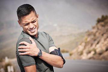 Image showing Fitness, injury and mockup with a sports man holding his shoulder in pain while running outdoor. Medical, exercise and anatomy with a male runner or athlete suffering from a hurt joint while training