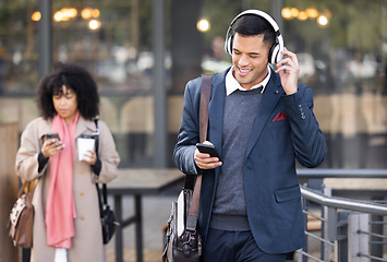 Image showing Businessman, walk in city with music, phone or headphones for audio, chat communication or social media. Corporate man, woman during travel in city with smartphone, typing or reading for networking