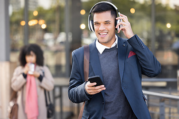 Image showing Phone, headphones and businessman walking in the city while listening to music, radio or podcast. Happy, smile and portrait of a professional corporate male commuting to work in the town street.