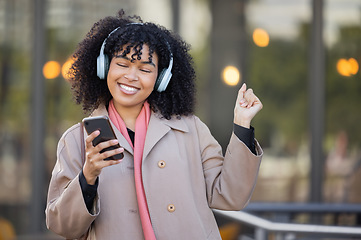 Image showing Happy woman listening to music in city, dancing with energy or mental health podcast for travel. Urban student in headphones, smartphone or 5g audio technology, streaming app on her way to university