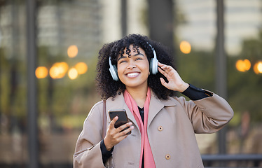 Image showing Black woman listening to music in city travel for mental health, energy and calm podcast with a smile. Happy, urban student in headphones or audio technology, streaming app on her way to university