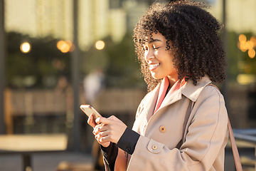 Image showing Communication, travel or black woman with phone for networking, social media or search in London street. Happy, smile or professional on smartphone for research, internet or blog content outdoor