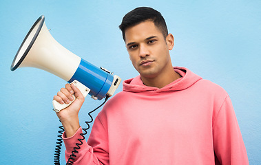 Image showing Man, portrait or megaphone for protest, human rights equality or freedom campaign on isolated blue background. Student, person or model with loud speaker for empowerment speech, justice or revolution