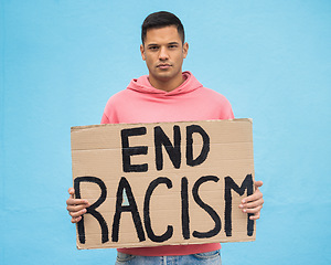 Image showing Portrait, sign and racism with a man in studio on a blue background for freedom at a march or rally. Government, politics and justice with a male protestor holding a for protest or equality