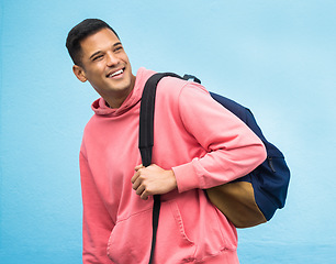 Image showing Man, backpack and university student happy in studio, laughing and smile on blue background. Young, handsome and college student excited for education, vision and career goal while standing isolated