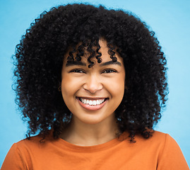 Image showing Happy, black woman or afro hairstyle portrait on isolated blue background in keratin treatment, self love or healthcare wellness. Headshot, smile or beauty model and curly brunette on urban city wall