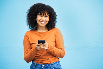 Image showing Happy black woman, fashion or phone typing on isolated blue background on Brazil city app, social media or internet. Smile, person or student model on mobile communication technology by wall mock up