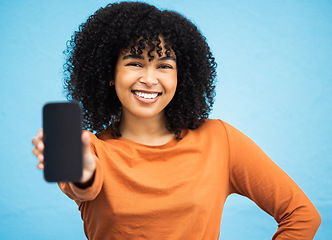 Image showing Happy black woman, hand or portrait of phone screen mockup on isolated blue background in social media app or web design. Smile, person or student on technology mock up, city contact or communication