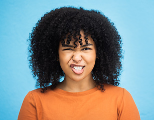 Image showing Portrait, emoji and woman with facial expression in studio for fun, relax and playful attitude on blue background. Face, comic and goofy black woman with a funny face, crazy and personality isolated