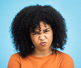 Image showing Black woman, portrait or angry facial expression on isolated blue background in mental health burnout. Headshot, model or person with mad, annoyed or frustrated face on backdrop mockup with afro hair