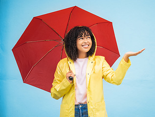 Image showing Travel, rain and woman with umbrella in a city, having fun and solo trip on wall background. Weather, hand and girl traveler enjoying rainfall, touching and excited, feeling and standing isolated