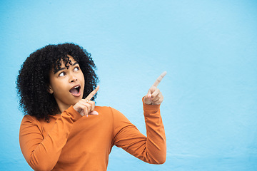 Image showing Black woman, wow or pointing hands at promotion mockup, advertising space or marketing mock up on blue background. Surprised, shocked or curious afro model with showing gesture at isolated sales deal