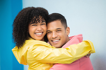 Image showing Couple, smile and hug in portrait with face, love and commitment, happiness isolated on blue background. Interracial relationship, support and together in studio with happy people and trust