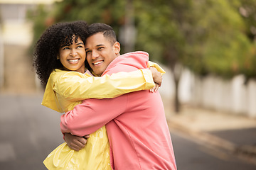 Image showing Happy couple, bonding and portrait hug on city road, street or urban sidewalk in travel, people date or holiday break. Smile, man and black woman in love embrace, security or trust cuddle for support