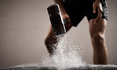 Image showing Workout, dust and hands hammer tire in studio isolated on a brown background mockup. Sports, fitness and male, athlete or man hammering tyre with chalk powder for training, exercise and muscle power.