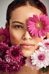 Image showing Flowers, woman and studio portrait for beauty, wellness and skincare with spring aesthetic by background. Model, girl and carnation plants for cosmetic health, healthy face glow or sustainable petals