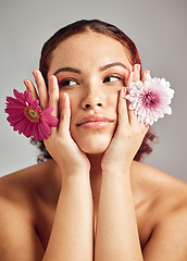 Image showing Woman, studio and face with flowers for thinking, beauty or healthy skincare for natural spring aesthetic by background. Model, girl and carnation plant for cosmetic health, skin glow or eco friendly