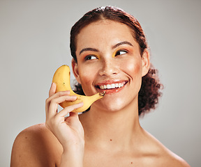 Image showing Beauty makeup, face and woman with banana phone for facial skincare glow, fruit detox or natural dermatology. Wellness health product, nutritionist food and happy model isolated on studio background