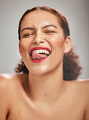 Image showing Beauty, face and woman, lipstick and makeup with tongue out and teeth, skin and happy isolated on studio background. Crazy, flirt and red lips with skincare and glow from cosmetic care and portrait