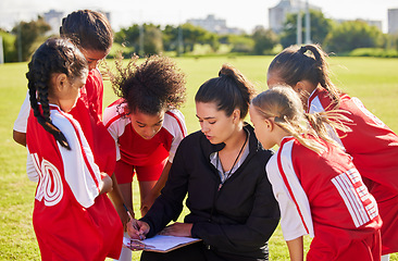 Image showing Planning, sports or coach with children for soccer strategy, training or health goals in Canada. team building, teamwork and woman coaching group of girls on football field for game, match or workout