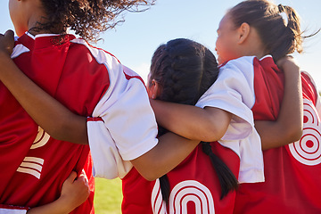 Image showing Girl, soccer group and back with huddle on field for match, contest or game with team building support. Female kids, football player children and hug for solidarity, diversity or motivation on pitch